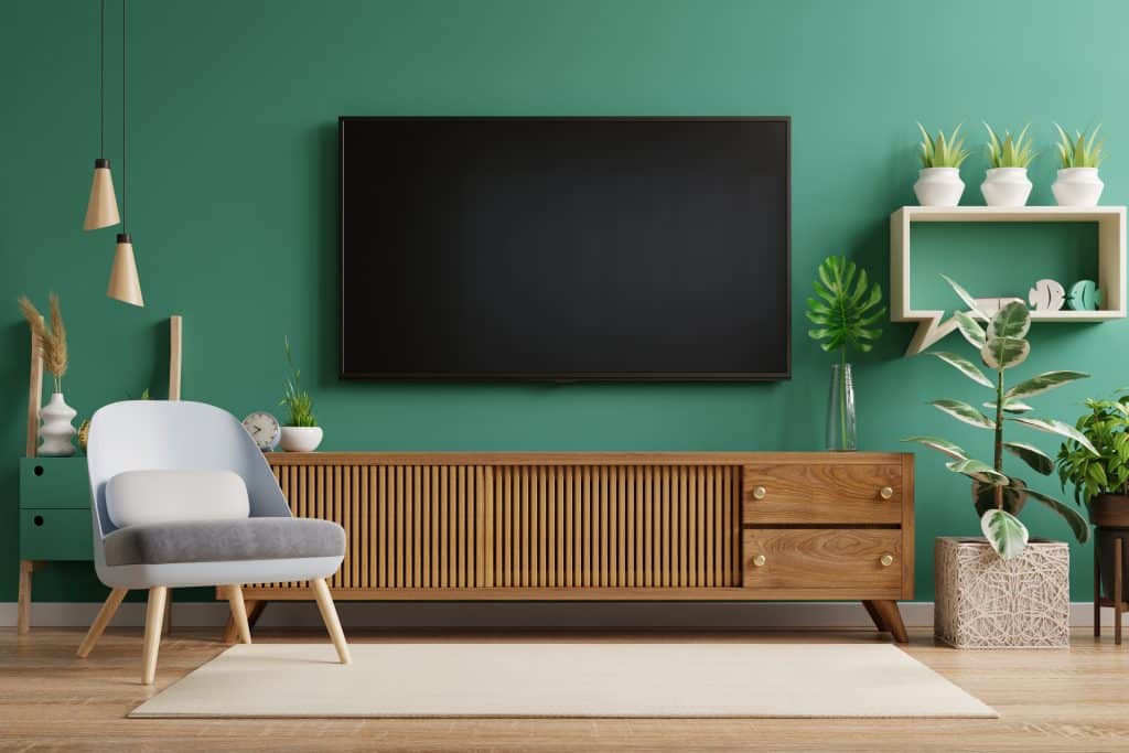 living room interior have tv cabinet and leather armchair with green wall 3d rendering